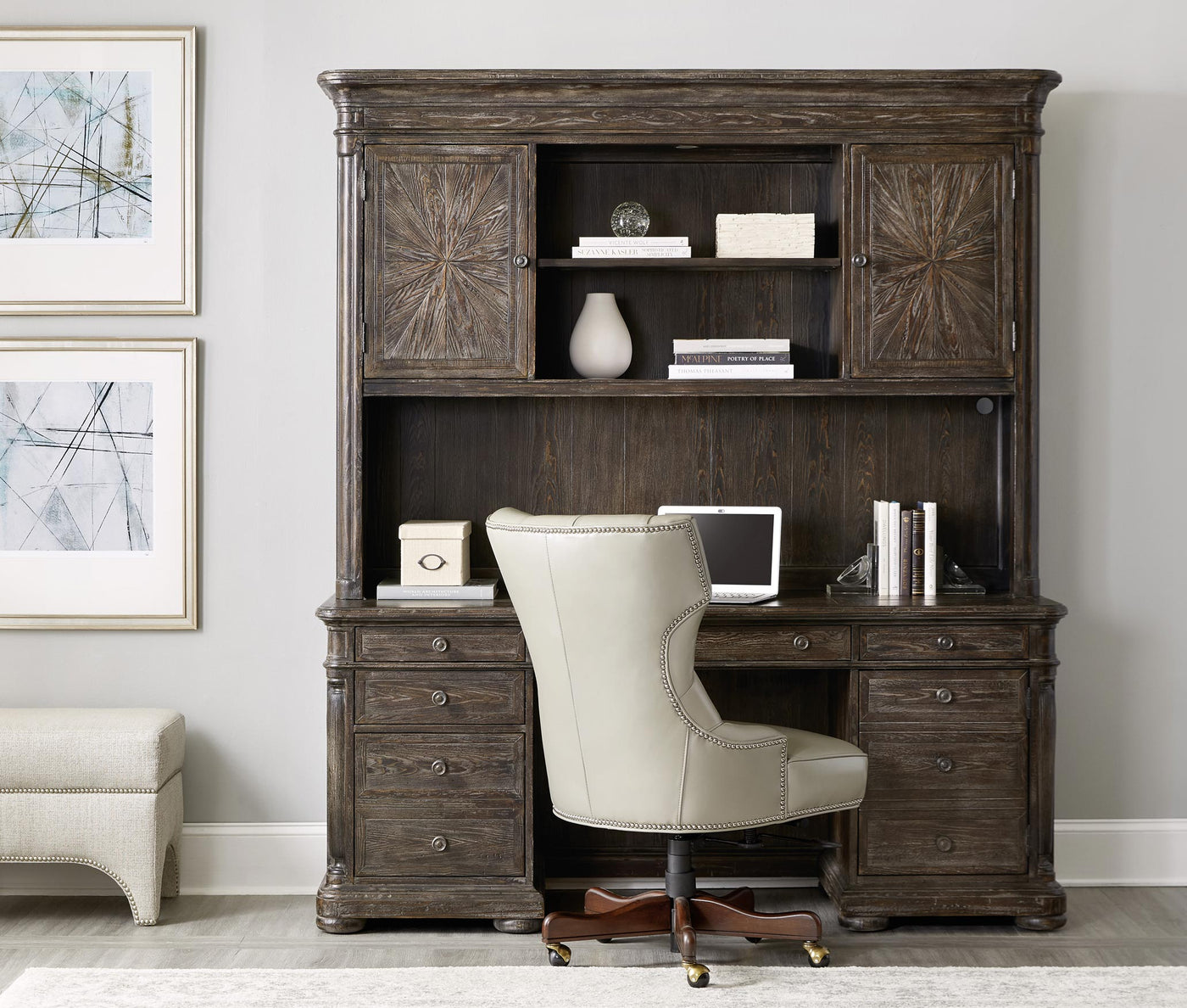 Lifestyle of a traditional dark wood executive desk that has a hutch on top of it, a rolling cream leather executive chair in front of it