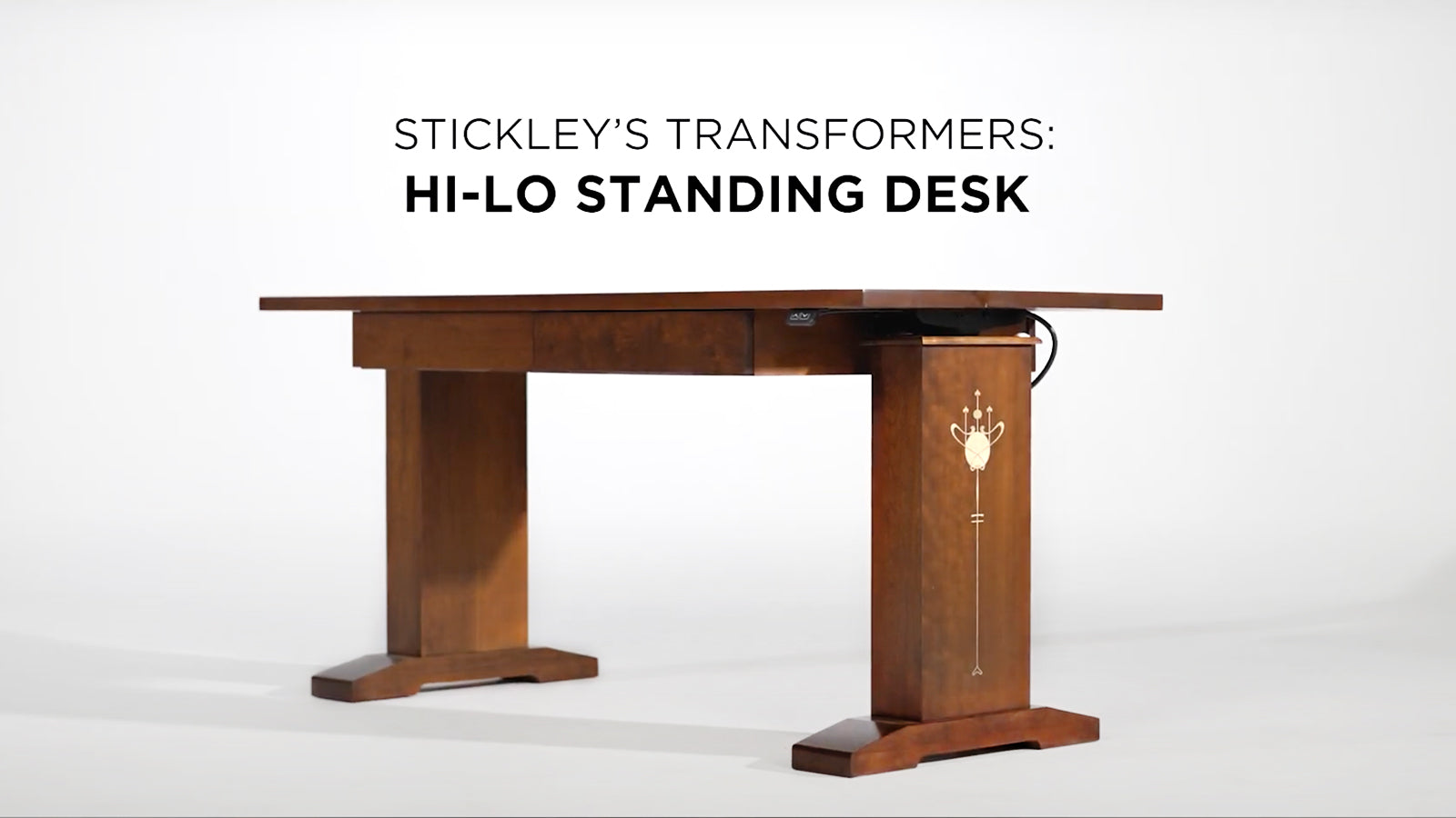 Still frame of a video showcasing the Hi-Lo standing desk against a white background with the words "Stickley's Transformers: Hi-Lo Standing Desk"