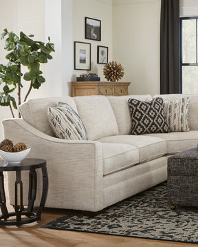 Fulton Lane living room sectional with black and white accent pillows, a black and white fabric ottoman is in front of it