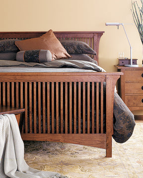 Lifestyle of a Mission Stickley bed with a dark gray comforter on top