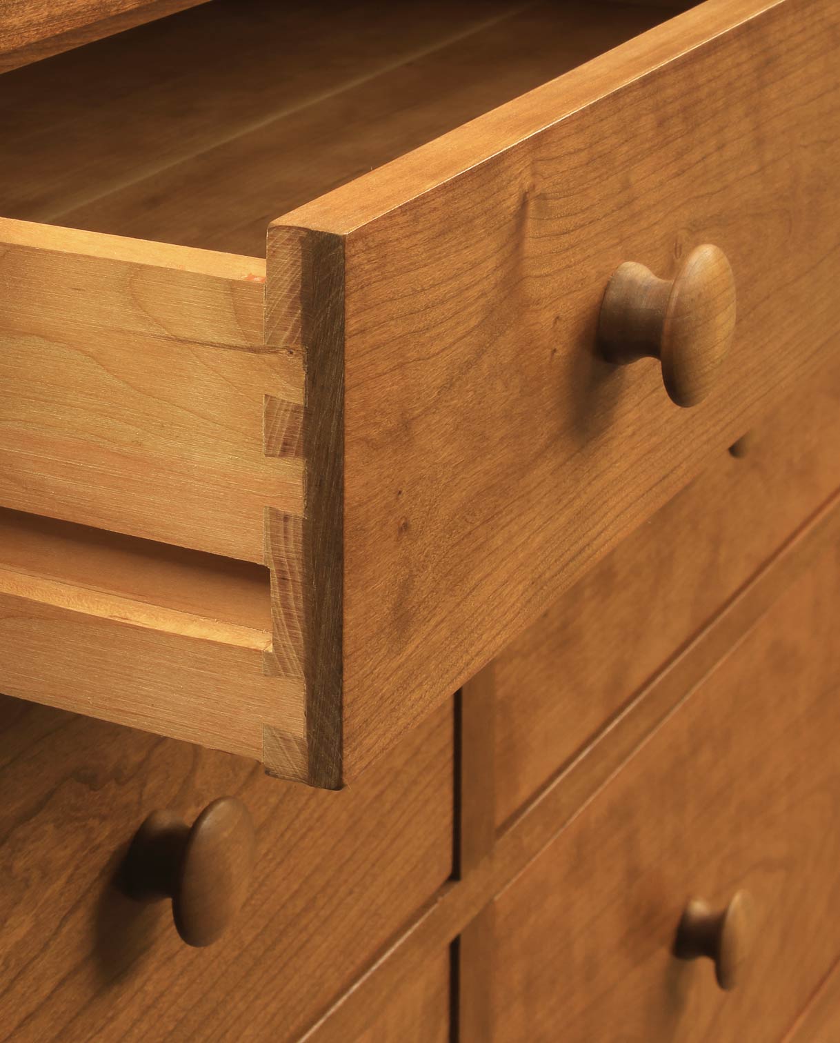 Close up of a Harvey Ellis drawer showing the drawer knobs