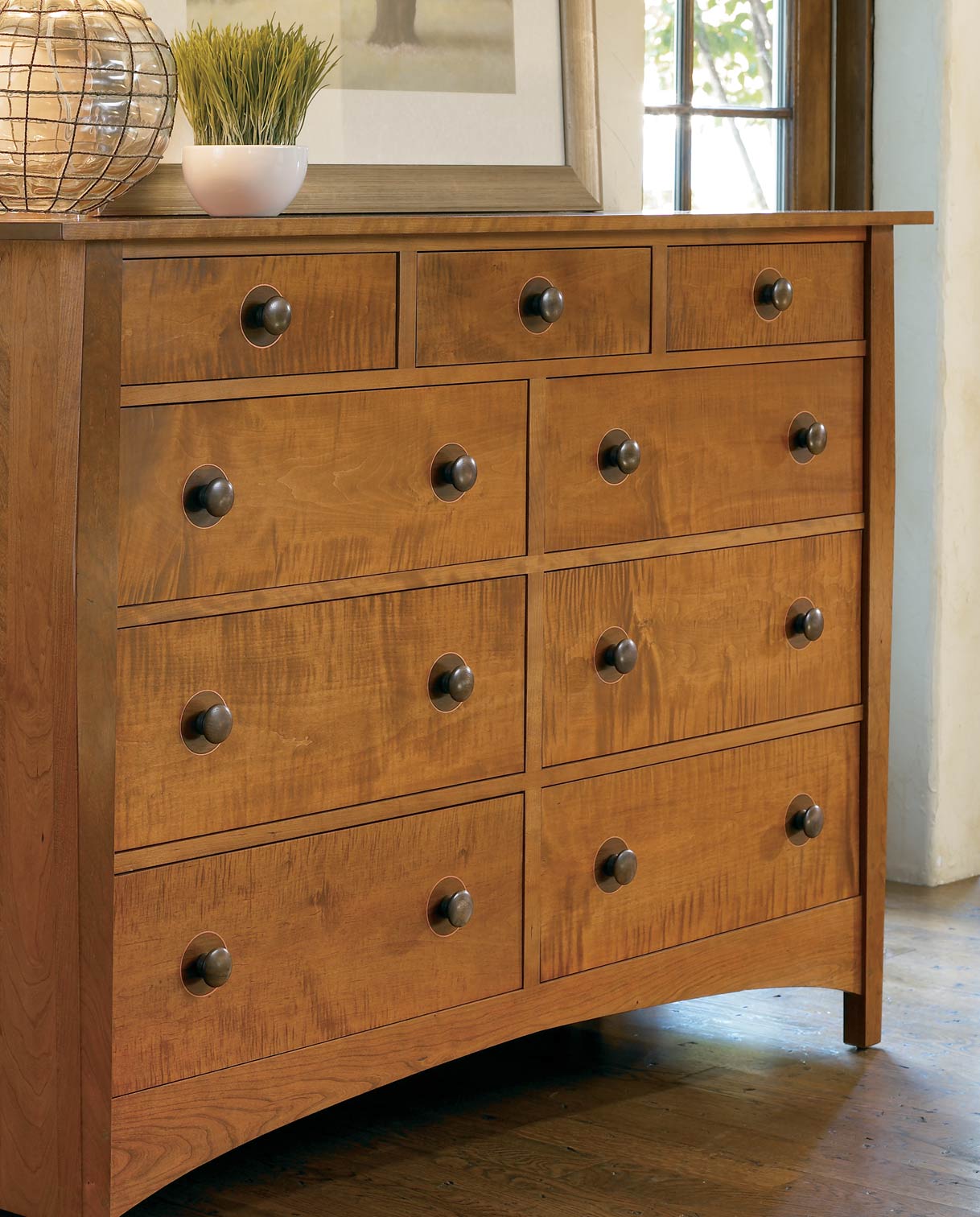 Close-up of a Harvey Ellis High Double Dresser with a curly maple front