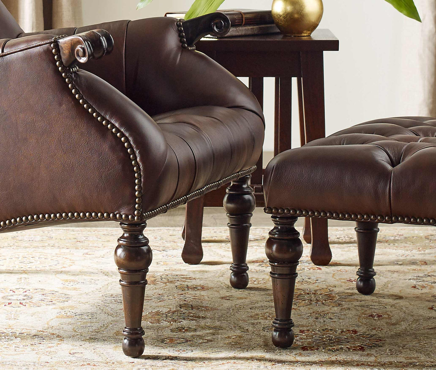 Close up of the Leopold's Chair and Ottoman showing the details of the hand tufting, and half in nailheads