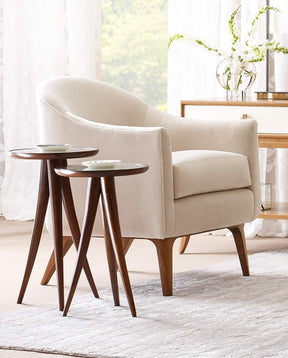 Lifestyle of a cream colored Martine Accent Chair with two Martine Drink tables next to it