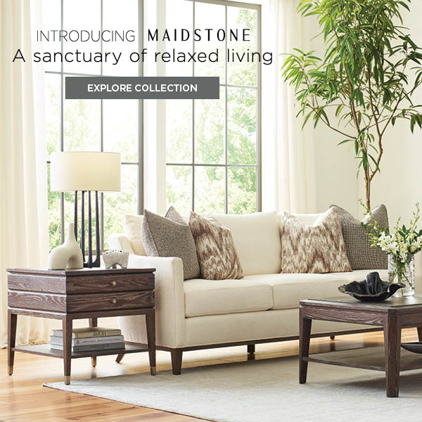 Lifestyle of the Maidstone Sofa and side table. They are sitting in front of a large window letting in natural light. The image has text on it reading "Introducing Maidstone. A sanctuary of relaxed living. Explore collection."