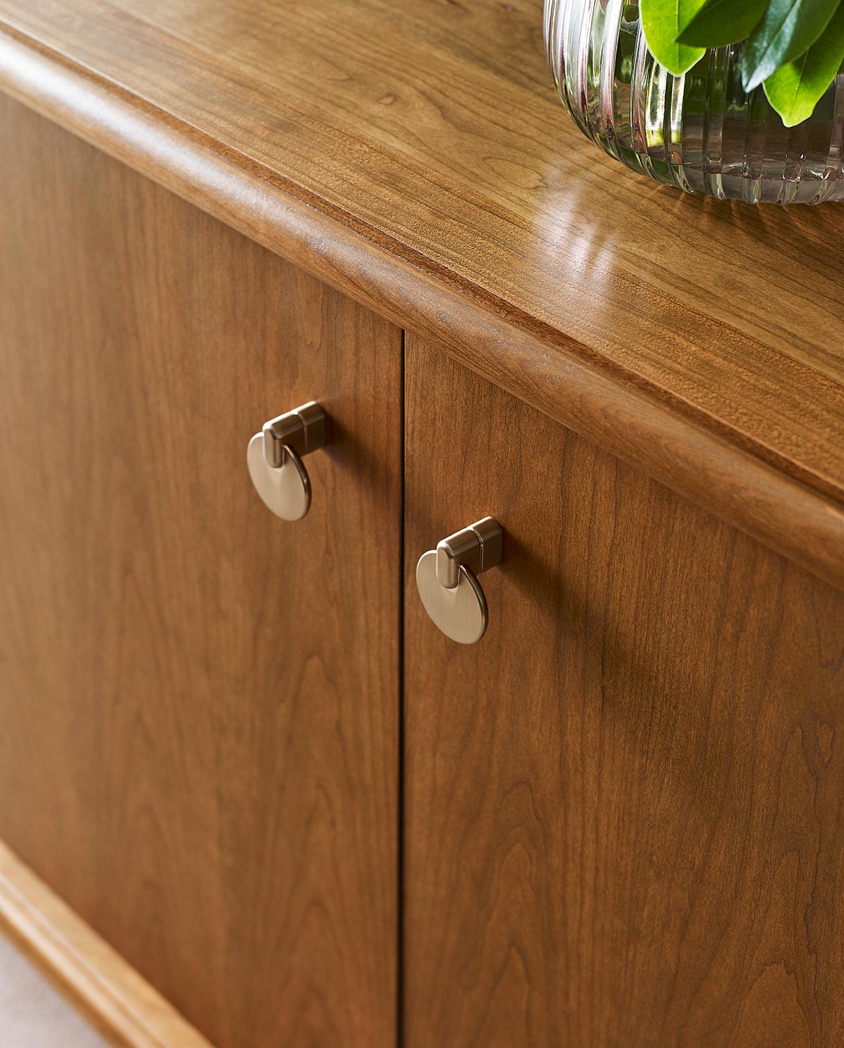 A close up of the brushed bronze pendant pulls used on Martine furniture