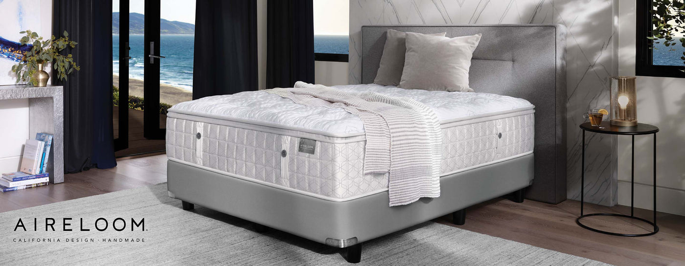 Aireloom Mattress on top of a gray upholstered bed frame