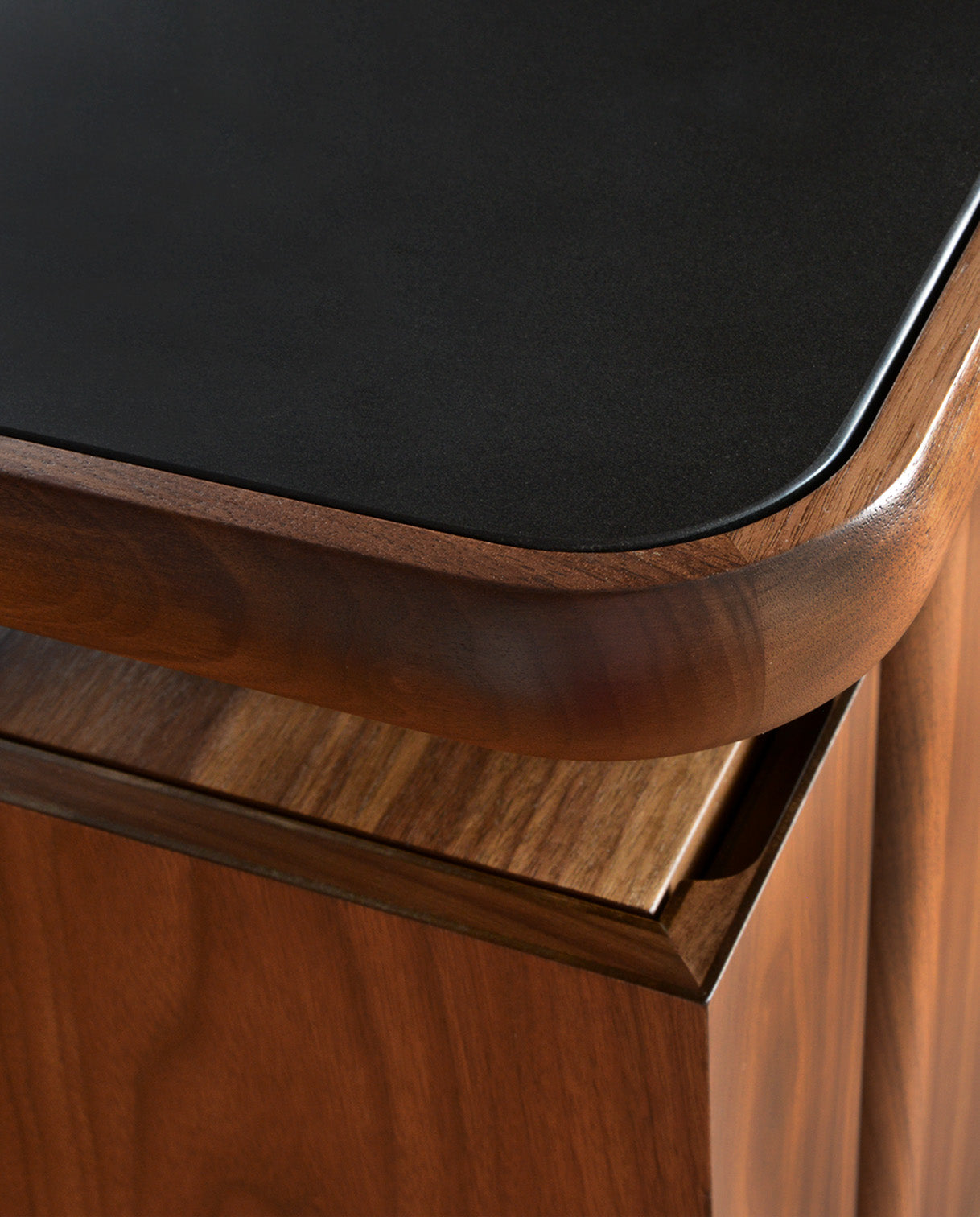 A close up of the top of a Walnut Grove Credenza showing the stone top option