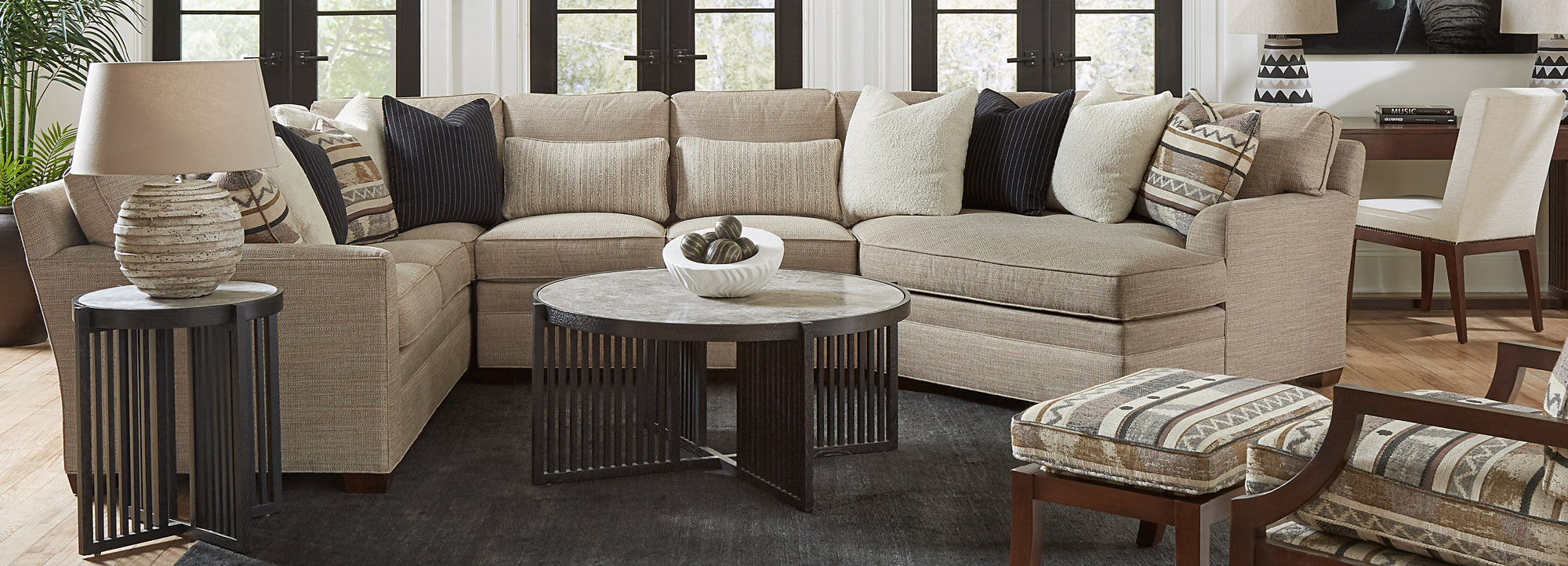 Stickley Furniture cream colored sectional with dark wood colored coffee and end tables