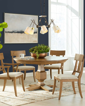 Lifestyle of a St. Lawrence Round Dining Table with two Curved Arm Chairs and two Curved Side Chairs