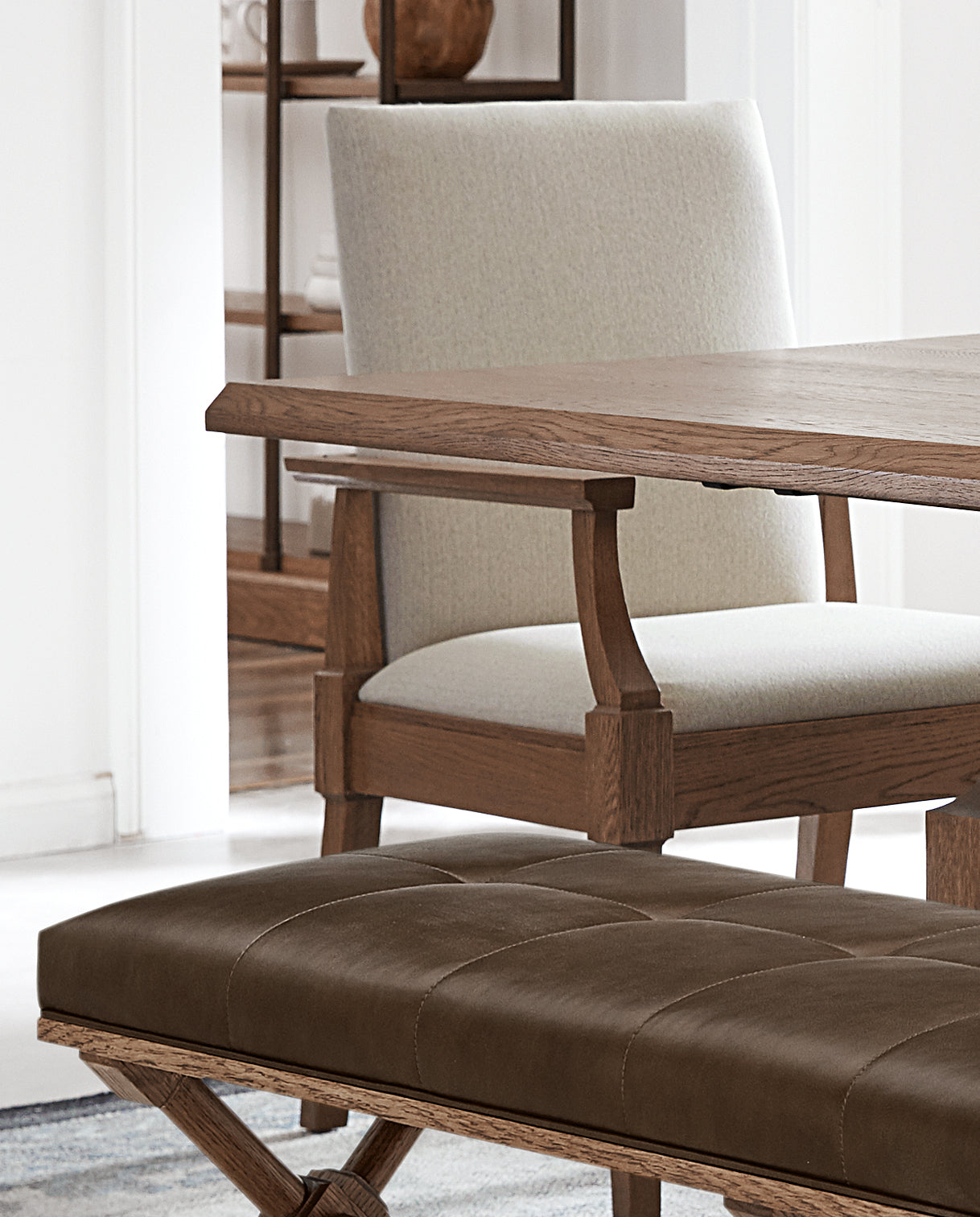 Close up of linen-colored fabric on a Hostess Chair and Mason Brown leather on the St. Lawrence Bench