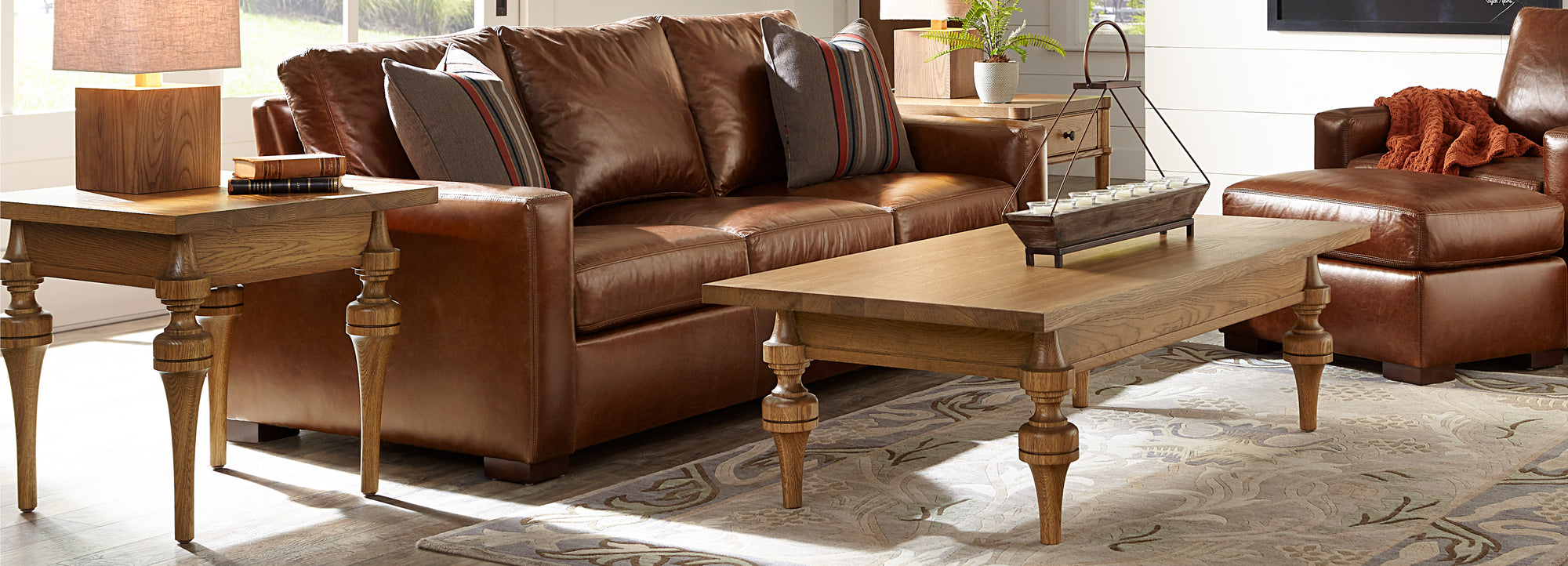 Stickley St. Lawrence collection coffee table and end table next to leather sofa and chair