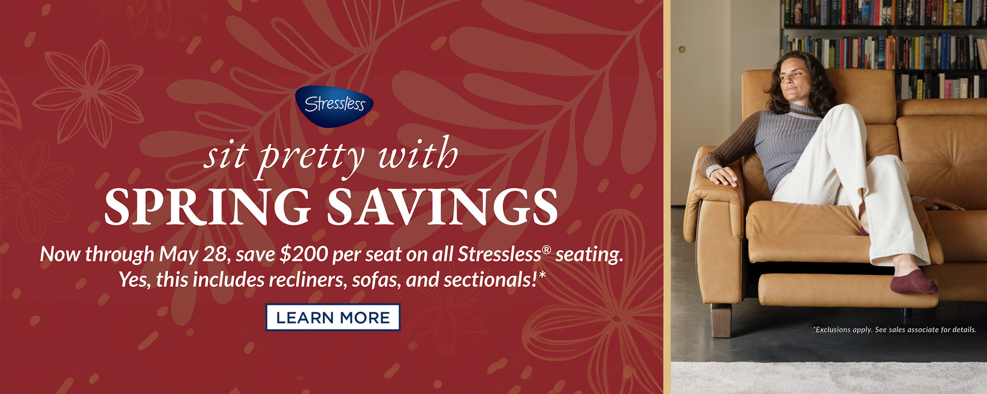 Banner for Stressless Spring Savings event. It features a maroon background with floral patterns and the slogan 'sit pretty with SPRING SAVINGS' in white and tan text. On the right side, a woman relaxes in a caramel-colored Stressless recliner, looking content. A bookshelf filled with books is behind her, indicating a cozy reading nook. The promotion offers $200 off per seat on all Stressless seating until May 28, with a 'LEARN MORE' button in the center for more details.