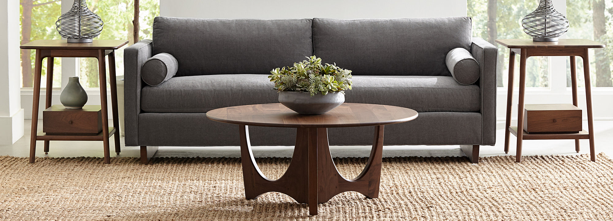 Stickley Walnut Grove collection end tables and coffee table beside gray sofa